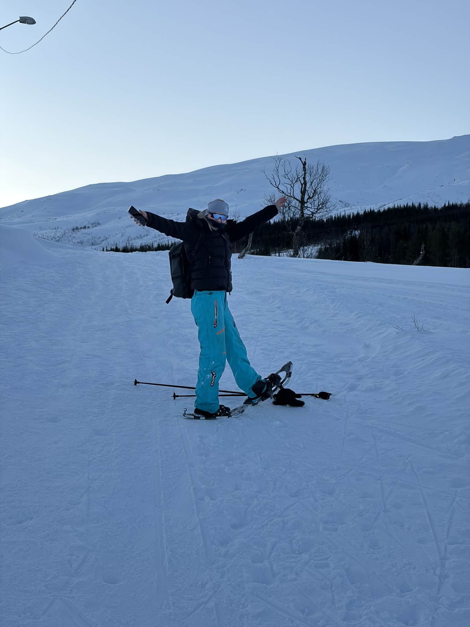Snowshoer walking the Kaldfjorden shoreline trail